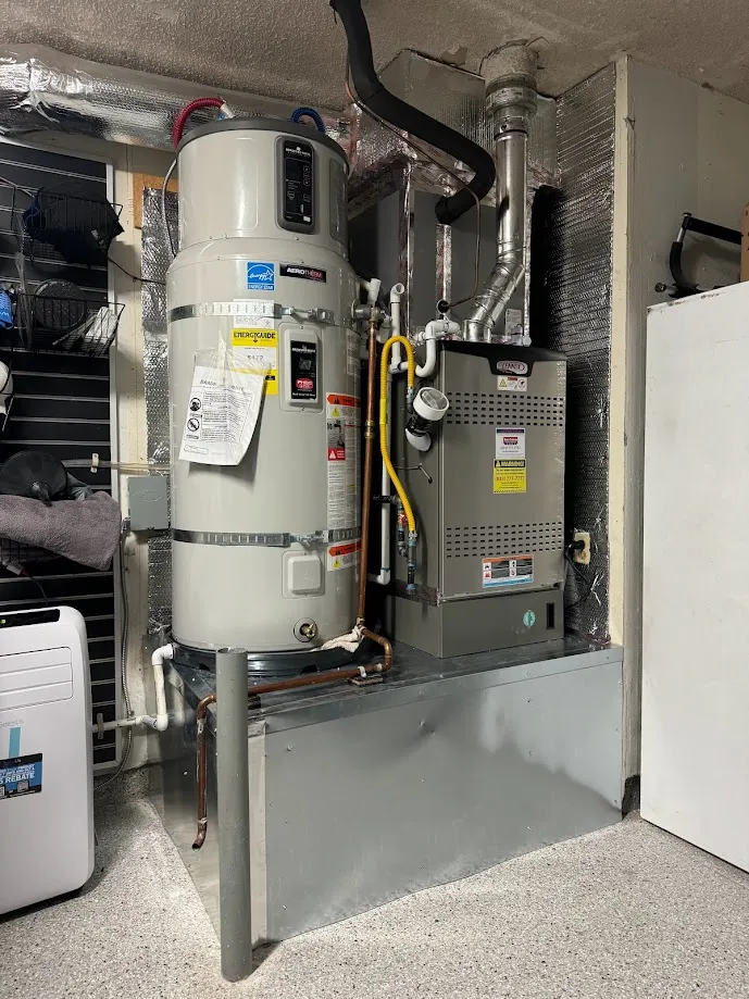 The Bradford White heat pump water heater that replaced it. It sits up on a stand and needs open air around it, because it makes hot water by pulling heat out of the garage.