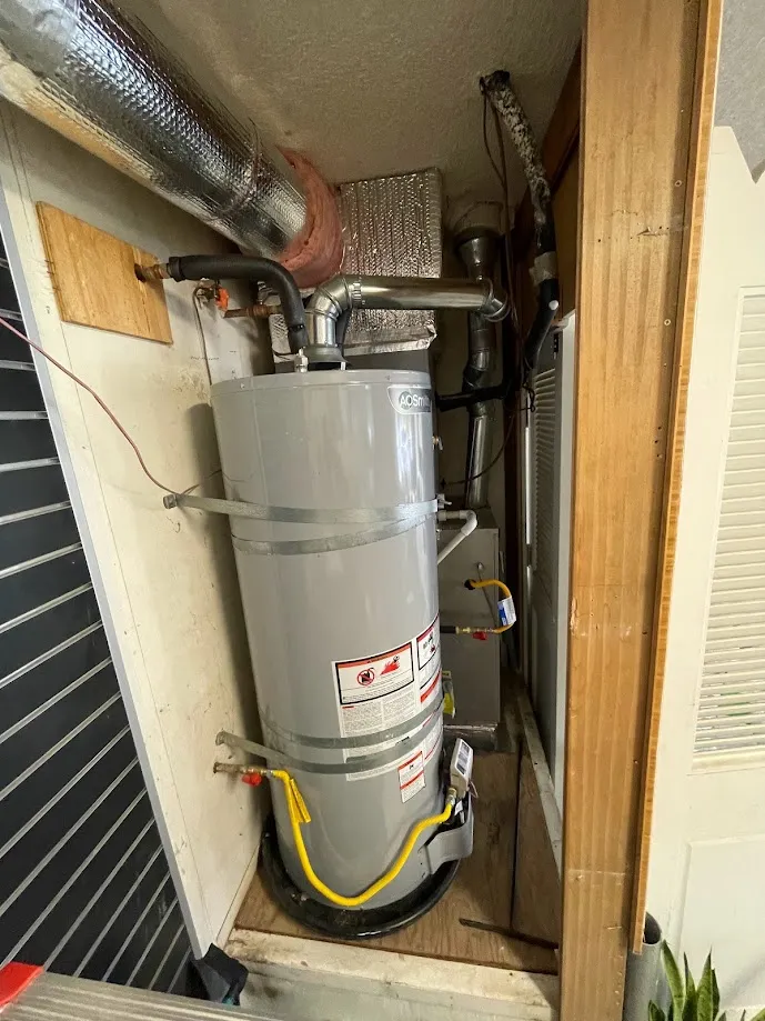 The old gas water heater, tucked in the garage closet a few feet from my desk. The flue pipe running out the top is the giveaway that it burns something to do its job.